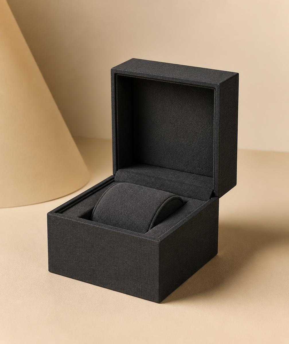 Charcoal matte buckram timepiece case open with a watch cushion inside